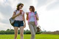 Communication of parent and teenager. Mother is talking to her teen daughter for 14 years, walking around the park on sunny summer