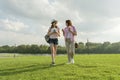 Communication of parent and teenager. Mother is talking to her teen daughter for 14 years, walking around the park on sunny summer