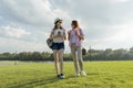 Communication of parent and teenager. Mother is talking to her teen daughter for 14 years, walking around the park on sunny summer