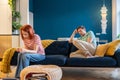 Upset European family couple wife and husband sit separately on sofa at home not talking after fight Royalty Free Stock Photo