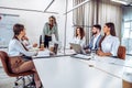 Communication and relaxed atmosphere during work.Young african business woman standing and talking with colleagues on the business