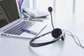 Communication support, call center and customer service help desk. VOIP headset on laptop computer keyboard Royalty Free Stock Photo