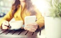 Close up of woman texting on smartphone at cafe Royalty Free Stock Photo