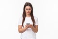 Communication, technology and lifestyle concept. Portrait of troubled and confused young woman reading strange message Royalty Free Stock Photo