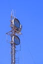 Communication telecom tower with radar and antennas against blue clear sky background Royalty Free Stock Photo