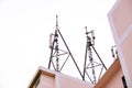 Communication tower with antennas on the top of building isolate on white background Royalty Free Stock Photo