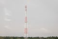 Communication tower of mobile and cellular devices with antennas on the background of a gray sky Royalty Free Stock Photo