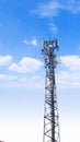 Communication tower network antenna for cellular telephone with blue cloudy sky Royalty Free Stock Photo