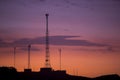 Communication towers on orange purple sky background, Peru