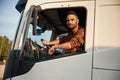 Communication by using radio. Young truck driver in casual clothes Royalty Free Stock Photo