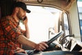Communication by using radio. Young truck driver in casual clothes Royalty Free Stock Photo
