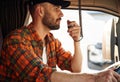 Communication by using radio. Young truck driver in casual clothes Royalty Free Stock Photo