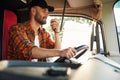 Communication by using radio. Young truck driver in casual clothes Royalty Free Stock Photo