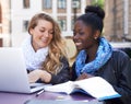 Communication, women students at campus with laptop and book. Teamwork or collaboration, females working together on Royalty Free Stock Photo