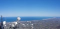 Communications antennas on the top of Mount Larun with the sea and the French coast