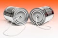 Communications and business calls concept of tin can telephone with string on orange Royalty Free Stock Photo