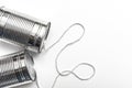 Communications and business calls concept of tin can telephone with string on orange Royalty Free Stock Photo