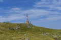 Communications cellular telecoms communications antenna in the top of the mountains with rusty communication shelter .