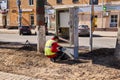 Communications engineer is repairing something in a wired telecommunications network distribution cabinet on a street in Perm,