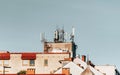 Cluster of mobile network broadcast cell repeaters on roof of building in city. Royalty Free Stock Photo