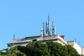 Cluster of mobile network broadcast cell repeaters on roof of building in city. Royalty Free Stock Photo