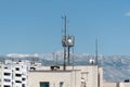 Cluster of mobile network broadcast cell repeaters on roof of building in city. Royalty Free Stock Photo