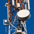 Communications tower with antennas on blue sky Royalty Free Stock Photo