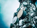Antennas over communications tower with the sky behind landscape, close-up Royalty Free Stock Photo