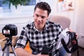 Communicative professional blogger sitting in his studio