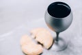 Communion still life. Unleavened bread, chalice of wine on grey background. Christian communion concept for reminder of Jesus Royalty Free Stock Photo