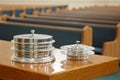 Communion Trays on Table Before Empty Church Pews Royalty Free Stock Photo