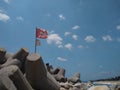 communist flag floating in the wind blue sky background, Pozhikkara beach Kollam Kerala