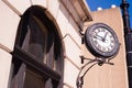 Community Clock Mounted on Building Close Corner Sidewalk Royalty Free Stock Photo