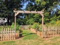 Community garden with wood fence, entrance to garden