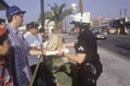 Community members giving lunch to policeman, South Central Los Angeles, California