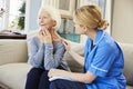 Community Nurse Visits Senior Woman Suffering With Depression