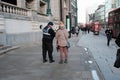 A community officer helping out a lady by providing information in Shoreditch, Uk