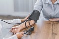 Female doctor checking blood pressure of old man Royalty Free Stock Photo