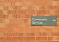 Community services sign on a red brick wall Royalty Free Stock Photo