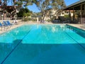 Community swimming pool and jacuzzi inside typical private condo complex. Royalty Free Stock Photo