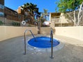 Community swimming pool and jacuzzi inside typical private condo complex. Royalty Free Stock Photo