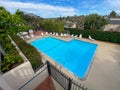 Community swimming pool and jacuzzi inside typical private condo complex. Royalty Free Stock Photo