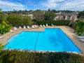 Community swimming pool and jacuzzi inside typical private condo complex. Royalty Free Stock Photo