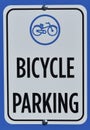 Commuter cycling infrastructure sign showing bicycle parking near a storage rack Royalty Free Stock Photo