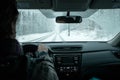 A commuter driving in a winter snow storm Royalty Free Stock Photo