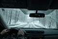 A commuter driving in a winter snow storm