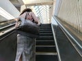 Female Commuter or shopper on an escalator