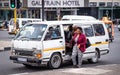 Commuter getting out of minibus taxi