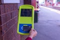 Commuter touching on a myki card reader at a train station platform