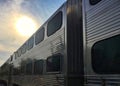 Sunset sky and commuter train disappearing into it after dropping off passengers. Royalty Free Stock Photo